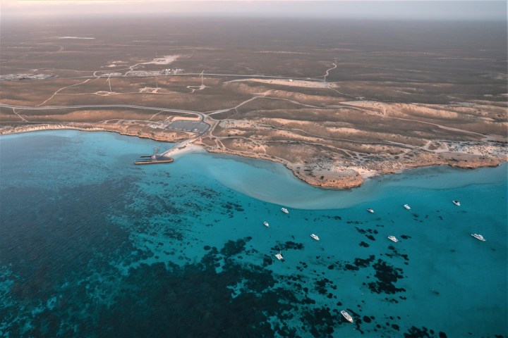 a body of water with a mountain in the background